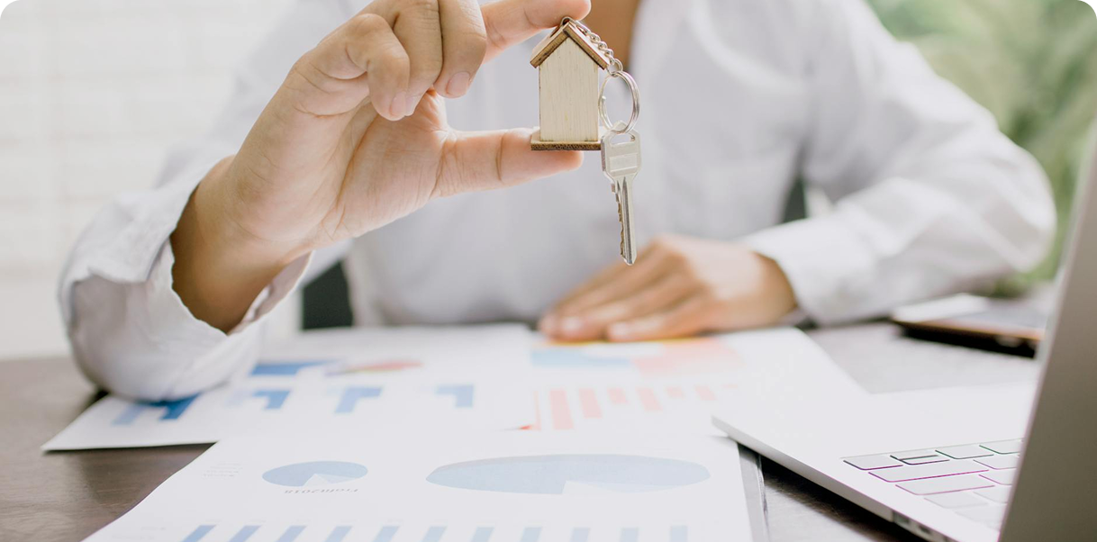 A real estate agent proudly holds a house key, signifying the joy of helping clients find their dream home.